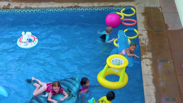 SAN JOSE DEL CABO BCS MEXICO-2020: Children Playing with Inflatable Toys in Pool