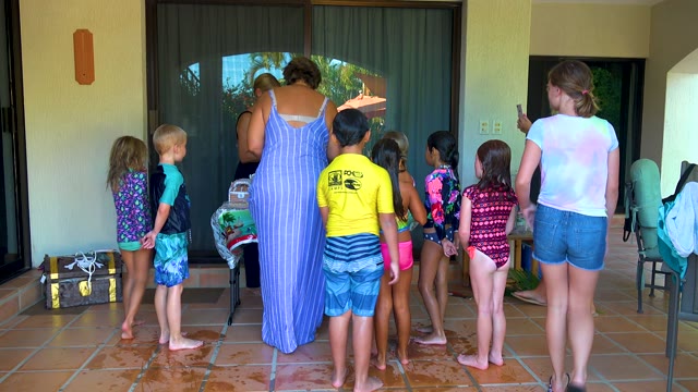 SAN JOSE DEL CABO BCS MEXICO-2020: Children and Adults Interacting on a Tiled Patio