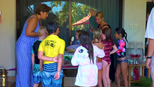 SAN JOSE DEL CABO BCS MEXICO-2020: Children and Adults Gathering Around a Table on a Patio