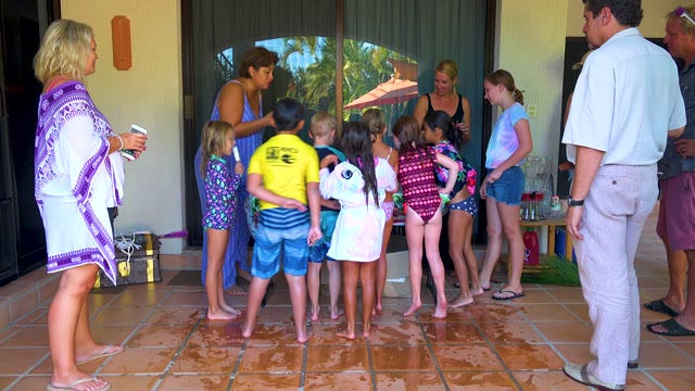 SAN JOSE DEL CABO BCS MEXICO-2020: Children and Adults Socializing on a Wet Patio
