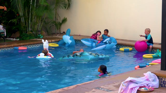 SAN JOSE DEL CABO BCS MEXICO-2020: Children Playing with Inflatable Toys in Swimming Pool