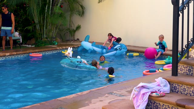 SAN JOSE DEL CABO BCS MEXICO-2020: Children Playing in a Backyard Swimming Pool