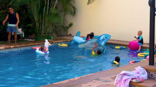 SAN JOSE DEL CABO BCS MEXICO-2020: Children Playing in a Backyard Swimming Pool