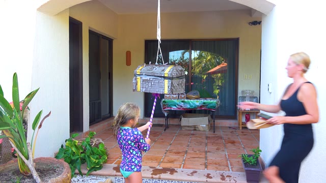 SAN JOSE DEL CABO BCS MEXICO-2020: Child Hitting Piñata on Outdoor Patio