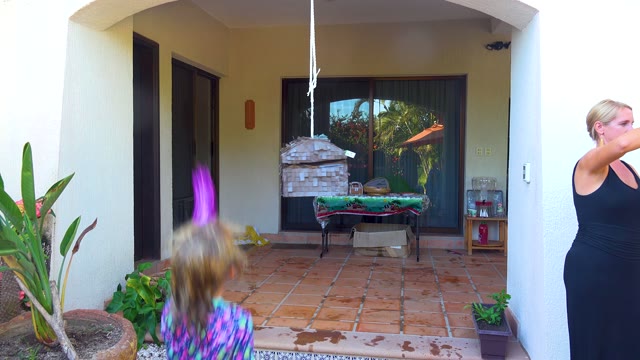 SAN JOSE DEL CABO BCS MEXICO-2020: Child Hitting a Piñata on a Patio