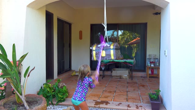 SAN JOSE DEL CABO BCS MEXICO-2020: Child Swinging Stick at Hanging Piñata