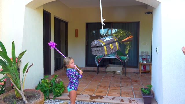 SAN JOSE DEL CABO BCS MEXICO-2020: Child Hitting Hanging Piñata on Patio
