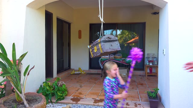 SAN JOSE DEL CABO BCS MEXICO-2020: Child Hitting a Piñata on a Patio