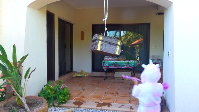 SAN JOSE DEL CABO BCS MEXICO-2020: Child in Costume Hitting a Piñata on a Patio