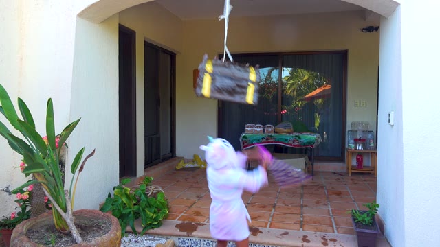 SAN JOSE DEL CABO BCS MEXICO-2020: Child in White Hooded Outfit Hitting a Piñata