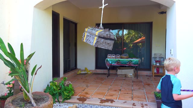 SAN JOSE DEL CABO BCS MEXICO-2020: Child Swinging Stick at Hanging Piñata