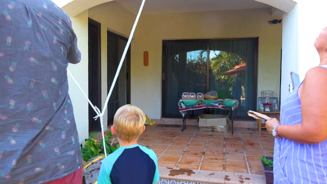 SAN JOSE DEL CABO BCS MEXICO-2020: Family Adjusting Rope on a Residential Patio