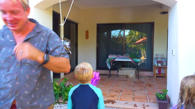 SAN JOSE DEL CABO BCS MEXICO-2020: Child Swinging at Hanging Piñata on Patio