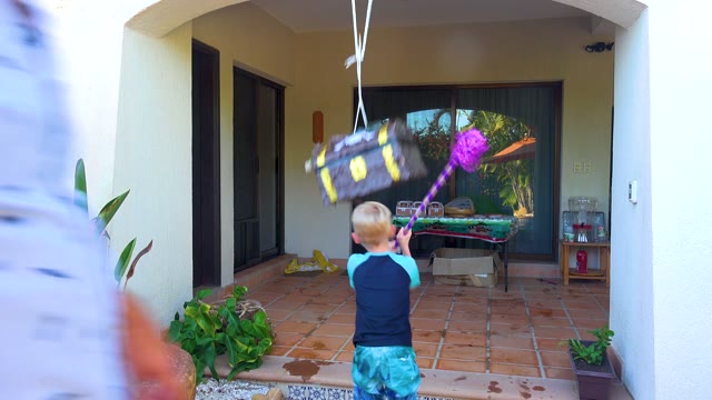 SAN JOSE DEL CABO BCS MEXICO-2020: Child Hitting Piñata on a Patio