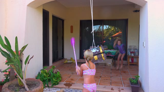 SAN JOSE DEL CABO BCS MEXICO-2020: Children Hitting a Piñata on a Patio