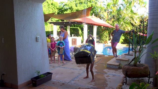 SAN JOSE DEL CABO BCS MEXICO-2020: Child Playing with Large Bag by Poolside