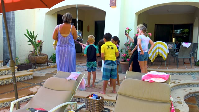 SAN JOSE DEL CABO BCS MEXICO-2020: Group of People Interacting on a Poolside Patio