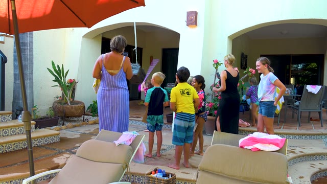 SAN JOSE DEL CABO BCS MEXICO-2020: Group Playing with a Water Toy on a Patio