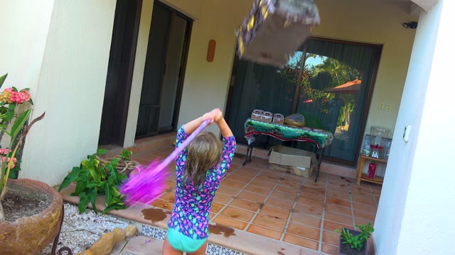 SAN JOSE DEL CABO BCS MEXICO-2020: Child Hitting a Piñata on a Patio