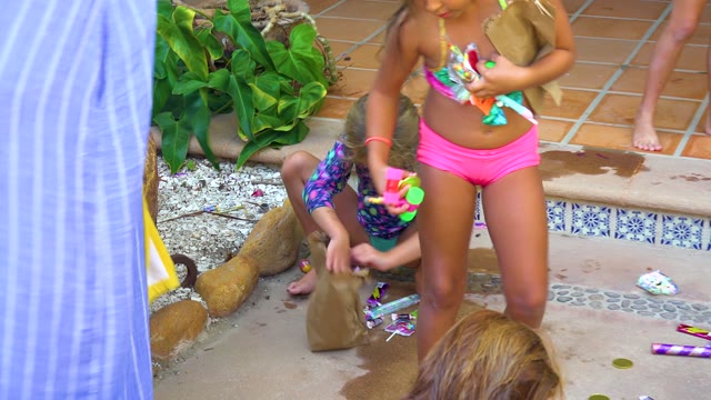 SAN JOSE DEL CABO BCS MEXICO-2020: Children Playing with Water Guns on Pool Deck