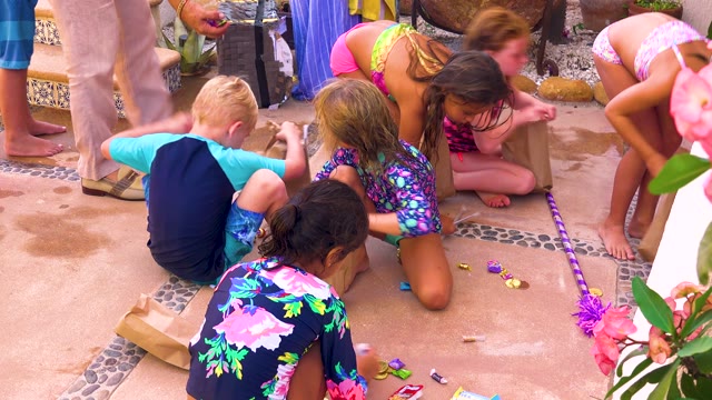 SAN JOSE DEL CABO BCS MEXICO-2020: Children Collecting Treats on a Tiled Patio