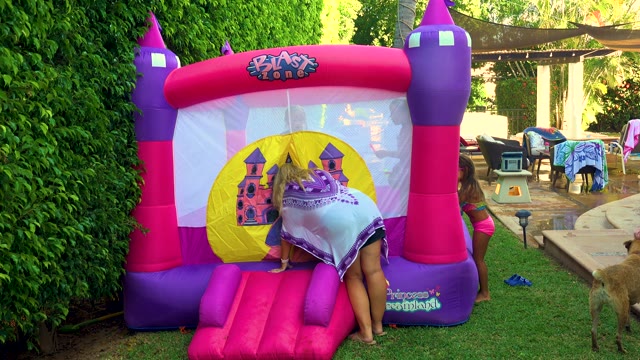 SAN JOSE DEL CABO BCS MEXICO-2020: Children Playing on a Pink and Purple Bouncy Castle