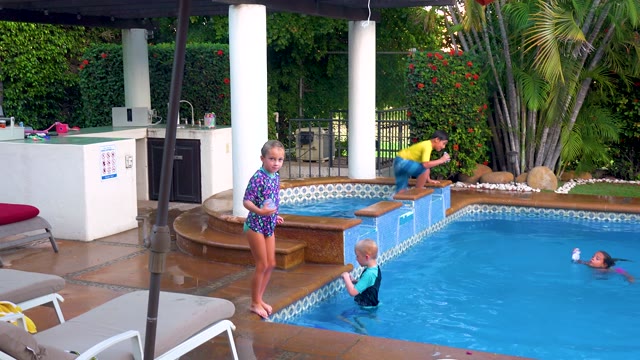 SAN JOSE DEL CABO BCS MEXICO-2020: Children Jumping Into a Swimming Pool