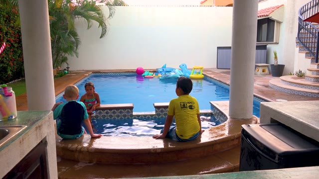 SAN JOSE DEL CABO BCS MEXICO-2020: Kids by Pool As Dog Moves Away