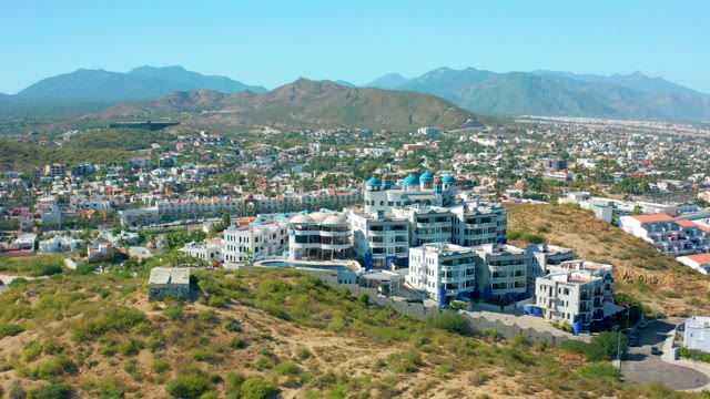 SAN JOSE DEL CABO MEXICO-2020: Hillside Buildings with Blue Domes and Distant Mountains