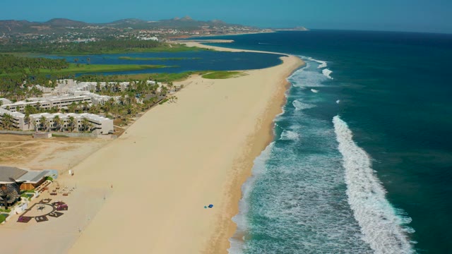 SAN JOSE DEL CABO MEXICO-2020: Sandy Beach with Ocean Waves and Coastal Structures