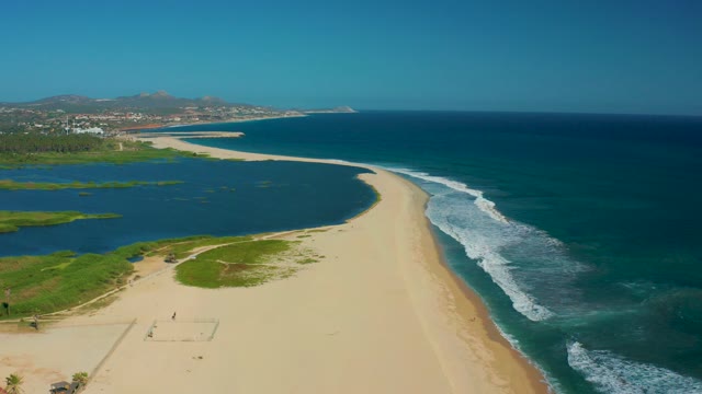 SAN JOSE DEL CABO MEXICO-2020: People Walking Along Sandy Beach with Ocean Waves