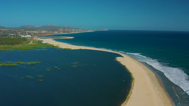 SAN JOSE DEL CABO MEXICO-2020: Ocean Waves Crashing on Sandy Beach with Lagoon