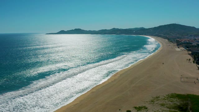 SAN JOSE DEL CABO MEXICO-2020: Sandy Beach with Rolling Ocean Waves and People