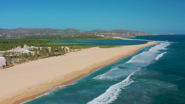 SAN JOSE DEL CABO MEXICO-2020: Sandy Beach with Ocean Waves and Coastal Development