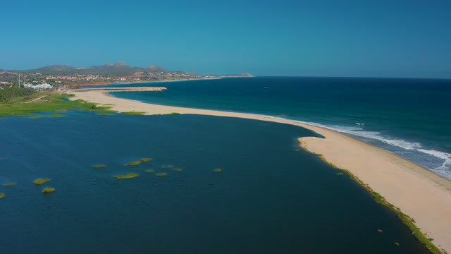 SAN JOSE DEL CABO MEXICO-2020: Sandy Beach Between Lagoon and Ocean with Gentle Waves