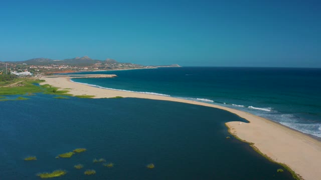 SAN JOSE DEL CABO MEXICO-2020: Estuary Merging with Ocean at Sandy Shore