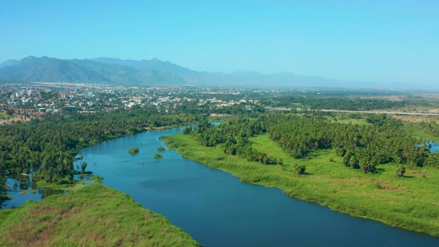 SAN JOSE DEL CABO MEXICO-2020: Meandering River in Lush Valley with Distant Town and Mountains