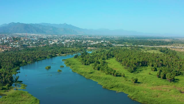 SAN JOSE DEL CABO MEXICO-2020: Boat Traveling on a Winding River with Green Banks