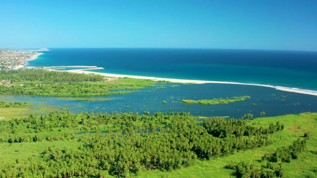 SAN JOSE DEL CABO MEXICO-2020: Coastal Lagoon with Sandy Shore and Forested Hills