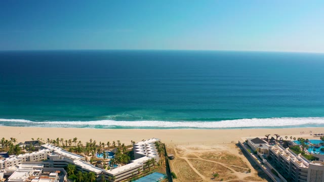 SAN JOSE DEL CABO MEXICO-2020: Resort Buildings Along Sandy Beach with Ocean Waves