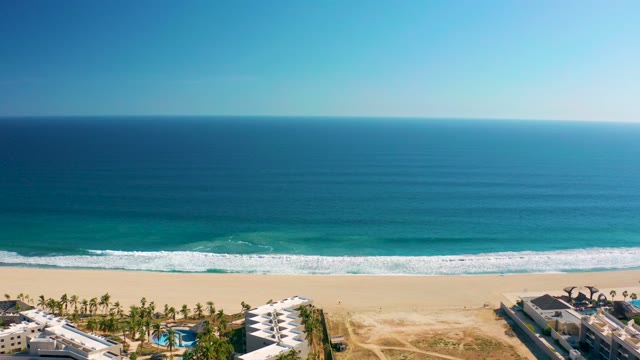 SAN JOSE DEL CABO MEXICO-2020: Beach Resort with Ocean Waves and White Buildings