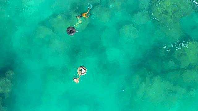 SAN JOSE DEL CABO BCS MEXICO-2020: People on Inflatable Rings Floating in Clear Turquoise Water