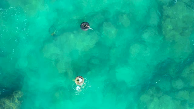 SAN JOSE DEL CABO BCS MEXICO-2020: People Floating on Inflatable Rings in Clear Turquoise Water
