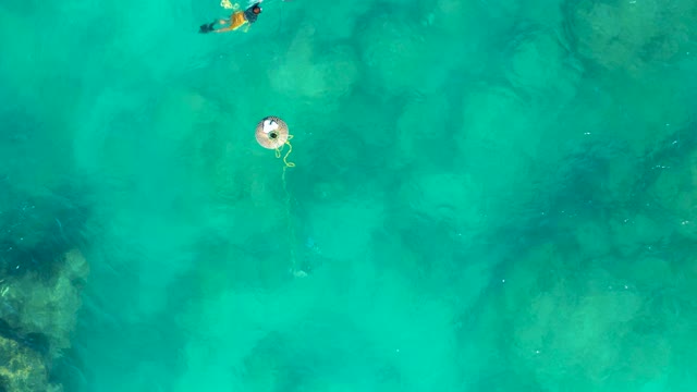 SAN JOSE DEL CABO BCS MEXICO-2020: Snorkeler Floating near Buoy in Clear Turquoise Water