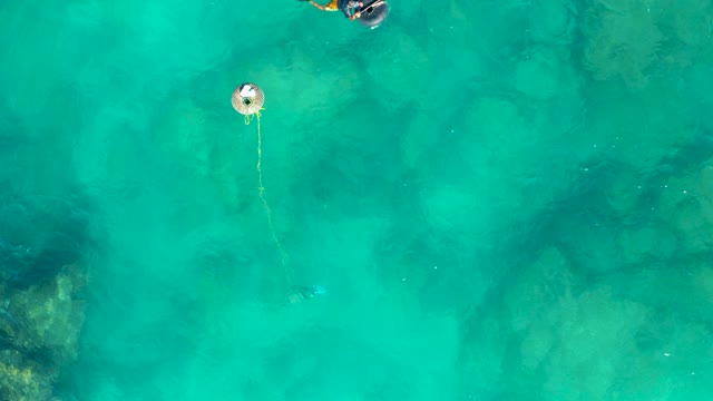 SAN JOSE DEL CABO BCS MEXICO-2020: Snorkeler Swimming with Buoy in Clear Turquoise Water