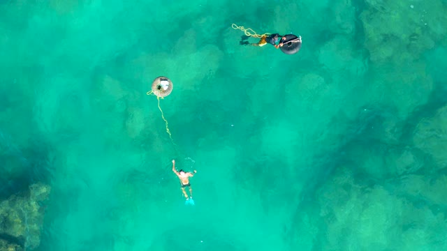 SAN JOSE DEL CABO BCS MEXICO-2020: Two People Snorkeling and Floating in Clear Turquoise Water