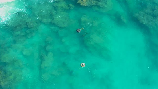 SAN JOSE DEL CABO BCS MEXICO-2020: Two People Swimming in Crystal Clear Turquoise Water