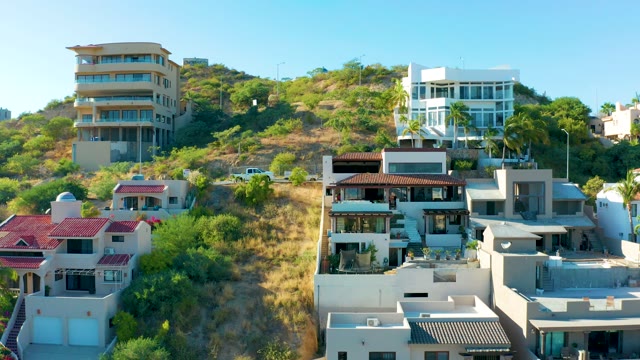 SAN JOSE DEL CABO BCS MEXICO-2020: Houses on a Hillside with a Car Ascending the Road
