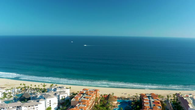 SAN JOSE DEL CABO BCS MEXICO-2020: Boat Moving Along Coastline Near Beach Resorts