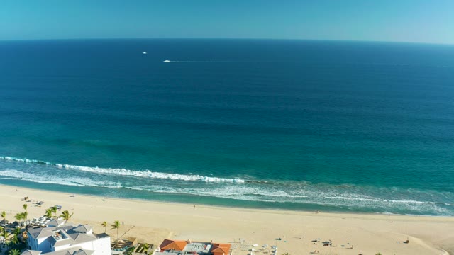 SAN JOSE DEL CABO BCS MEXICO-2020: Boat Moving Across Ocean Near Sandy Shoreline